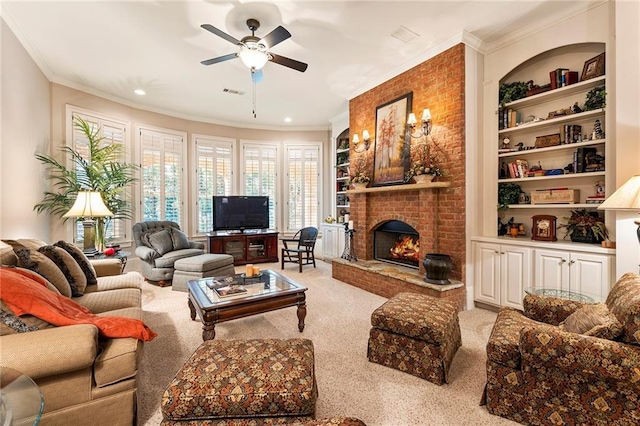 carpeted living room with ornamental molding, ceiling fan, built in features, and a fireplace