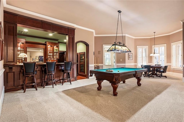 game room featuring light colored carpet, ornamental molding, bar area, and pool table