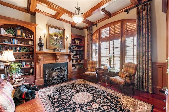 sitting room with coffered ceiling, built in shelves, dark hardwood / wood-style floors, and beamed ceiling