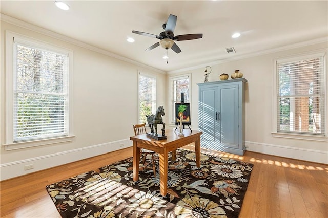 office with ornamental molding, plenty of natural light, and light hardwood / wood-style floors