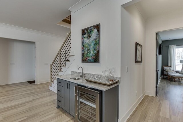 6014 Warpath Rd, Flowery Branch, GA 30542 - indoor wet bar with beverage cooler, light wood-style floors, stairway, and baseboards