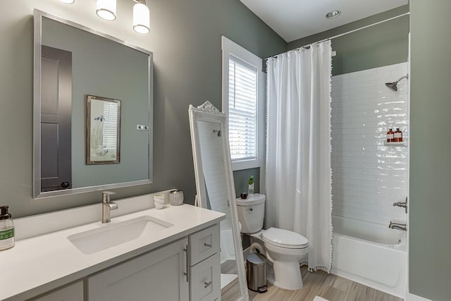 6014 Warpath Rd, Flowery Branch, GA 30542 - full bathroom with toilet, vanity, wood finished floors, and shower / tub combo with curtain
