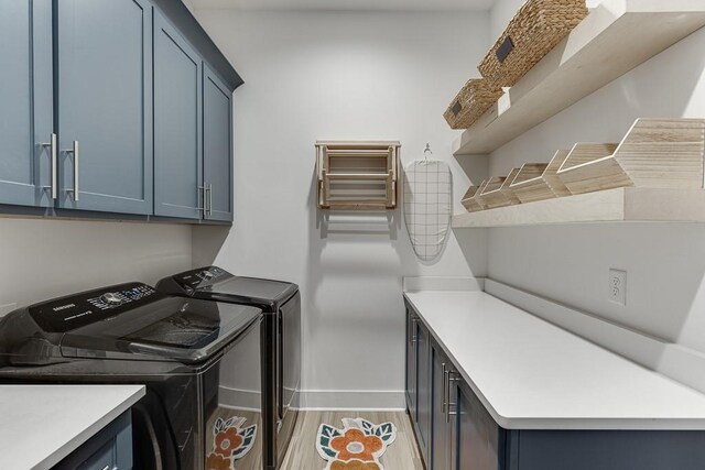 6014 Warpath Rd, Flowery Branch, GA 30542 - laundry room with cabinet space, washing machine and clothes dryer, baseboards, and light wood-type flooring