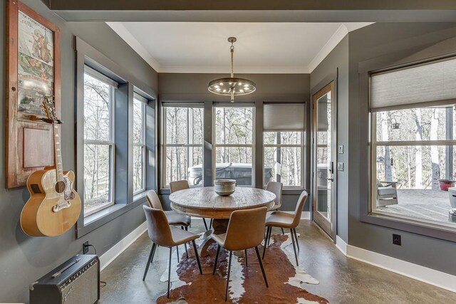 6014 Warpath Rd, Flowery Branch, GA 30542 - dining space with concrete floors, baseboards, a chandelier, and crown molding