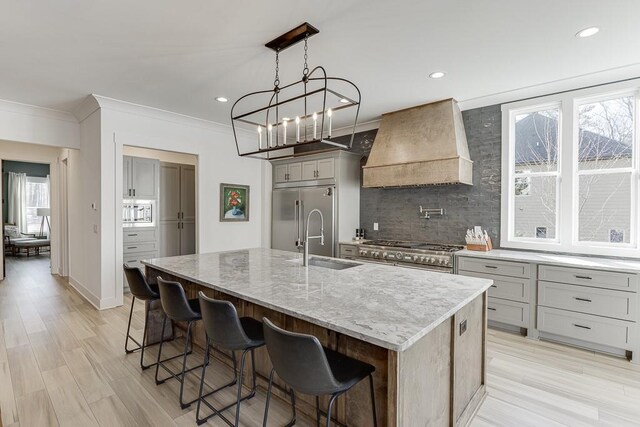 6014 Warpath Rd, Flowery Branch, GA 30542 - kitchen with custom exhaust hood, built in appliances, a sink, gray cabinets, and decorative backsplash