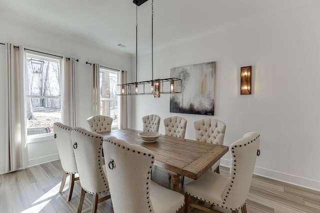 6014 Warpath Rd, Flowery Branch, GA 30542 - dining area with a chandelier, baseboards, and light wood-style flooring