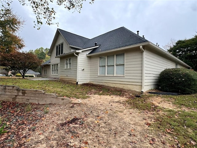 back of property with a shingled roof