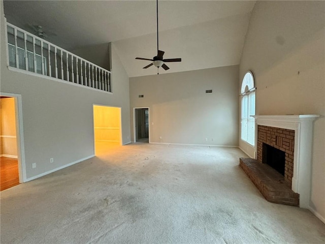 unfurnished living room with high vaulted ceiling, carpet floors, a fireplace, a ceiling fan, and baseboards