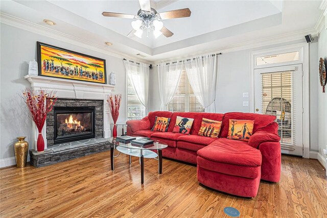 725 Windsor Place Cir SW, Grayson, GA 30017 - living room with a raised ceiling, a fireplace, wood finished floors, ornamental molding, and a ceiling fan