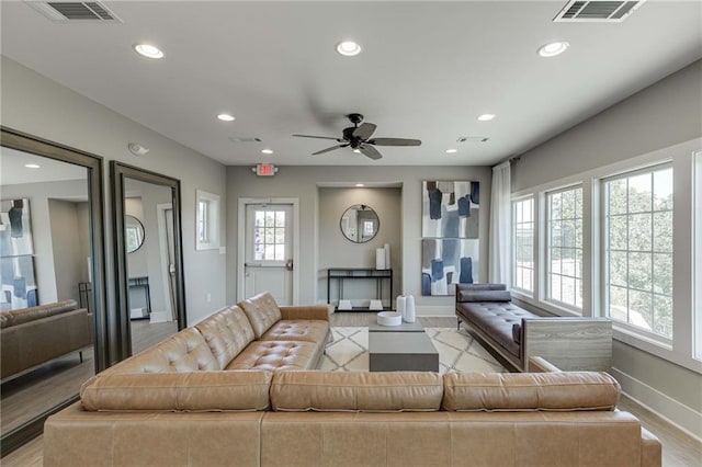 living room featuring ceiling fan and light wood-type flooring