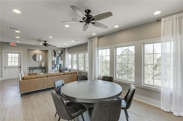 dining space with ceiling fan and light hardwood / wood-style floors