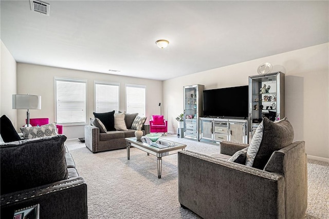 living area with baseboards, carpet flooring, and visible vents
