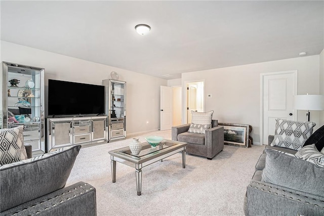 living area featuring baseboards and carpet