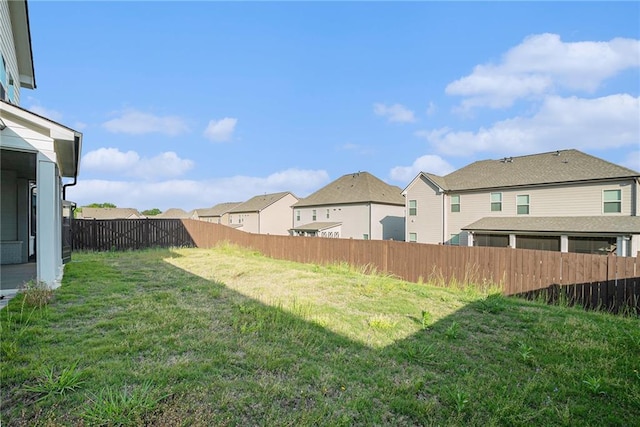 view of yard featuring a residential view and a fenced backyard
