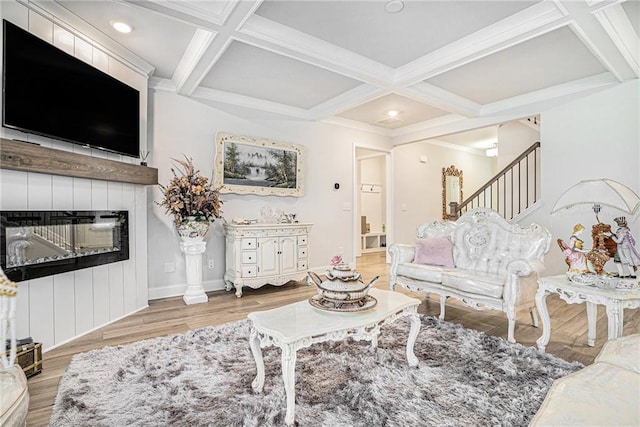 living area with beam ceiling, wood finished floors, and coffered ceiling