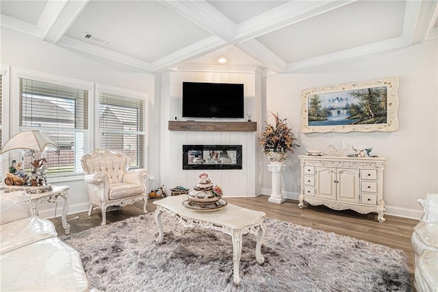 living room with beamed ceiling, baseboards, visible vents, and wood finished floors