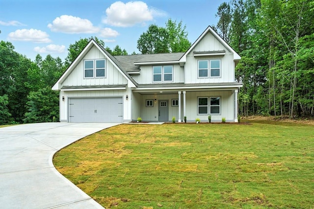 112 Radian Ct, Dallas, GA 30132 - view of front of property featuring driveway, board and batten siding, a front yard, covered porch, and a garage