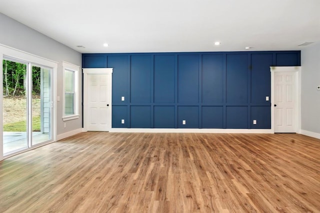 112 Radian Ct, Dallas, GA 30132 - unfurnished living room featuring light wood finished floors, a decorative wall, baseboards, and recessed lighting