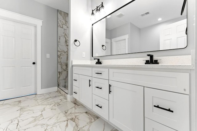 112 Radian Ct, Dallas, GA 30132 - bathroom featuring double vanity, marble finish floors, a marble finish shower, baseboards, and recessed lighting