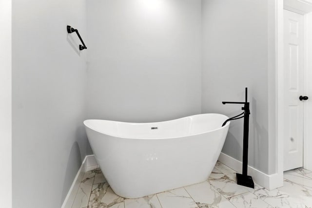 112 Radian Ct, Dallas, GA 30132 - bathroom featuring marble finish floors, baseboards, and a freestanding tub