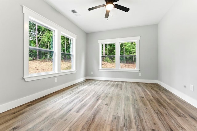 112 Radian Ct, Dallas, GA 30132 - spare room featuring plenty of natural light, wood finished floors, ceiling fan, and baseboards