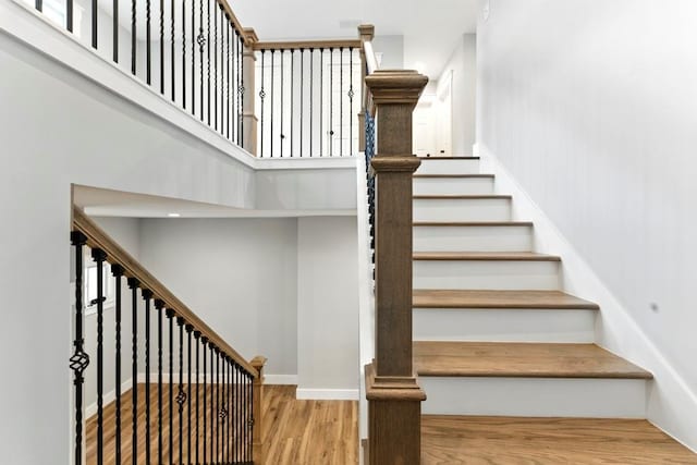 112 Radian Ct, Dallas, GA 30132 - stairway featuring a towering ceiling, wood finished floors, and baseboards