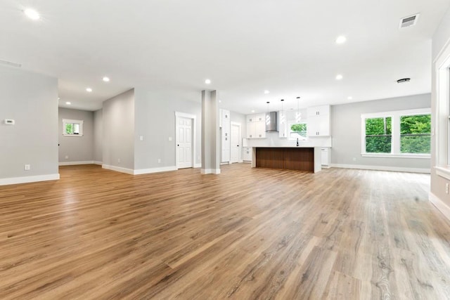 112 Radian Ct, Dallas, GA 30132 - unfurnished living room featuring baseboards, recessed lighting, and light wood-style flooring