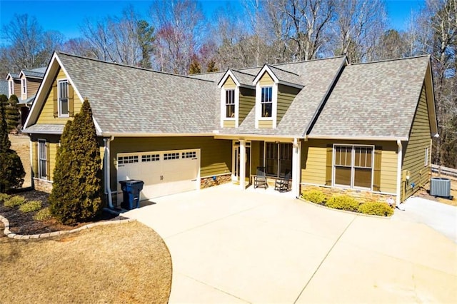 view of front of home featuring concrete driveway, central air condition unit, a garage, and stone siding