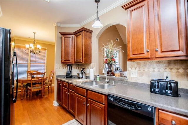 kitchen with black appliances, light wood-style flooring, a sink, decorative light fixtures, and a chandelier