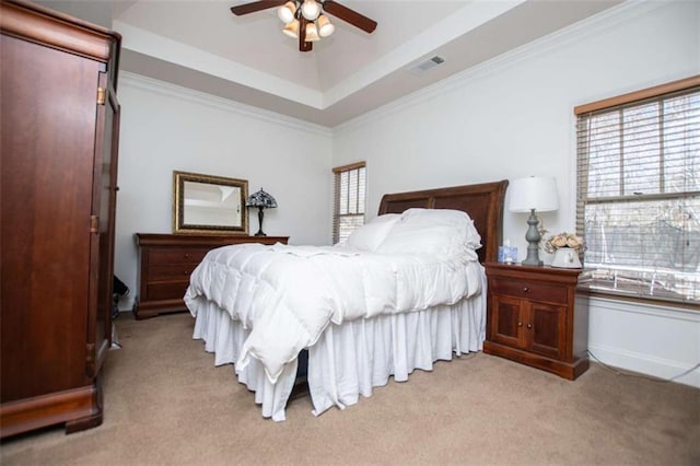 bedroom featuring a raised ceiling, ornamental molding, visible vents, and light carpet