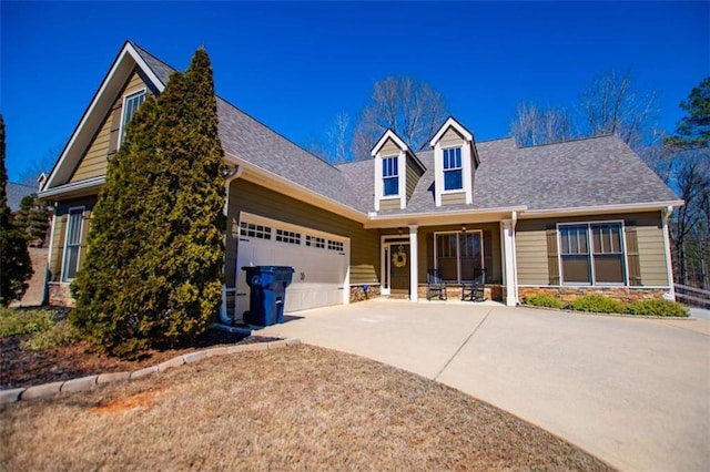 new england style home featuring an attached garage, stone siding, driveway, and a shingled roof