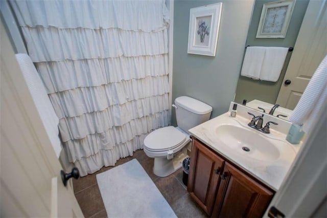 bathroom with a shower with shower curtain, toilet, vanity, and tile patterned flooring