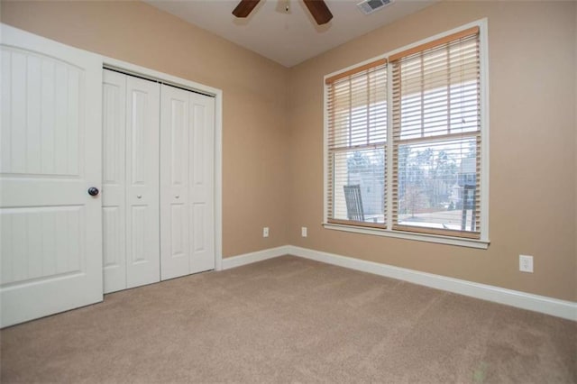 unfurnished bedroom with a closet, baseboards, visible vents, and carpet flooring