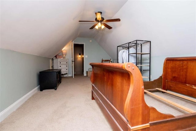 carpeted bedroom with baseboards, lofted ceiling, and a ceiling fan