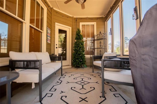 sunroom / solarium featuring a ceiling fan