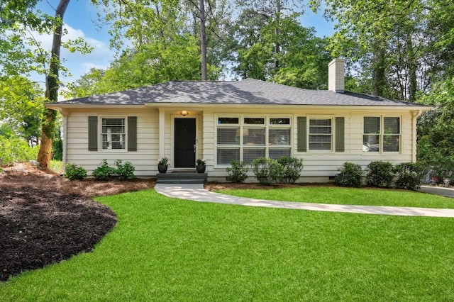 ranch-style home with crawl space, a chimney, and a front lawn