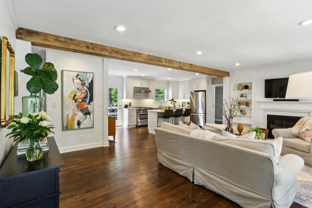 living area featuring baseboards, recessed lighting, beam ceiling, and dark wood-type flooring