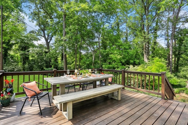 wooden terrace featuring outdoor dining area