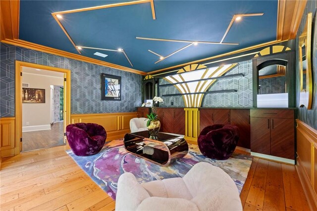 sitting room featuring light wood-type flooring and crown molding