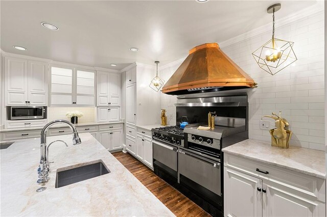 kitchen with black gas stove, dark hardwood / wood-style floors, sink, decorative light fixtures, and light stone countertops