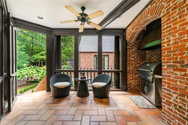 unfurnished sunroom featuring ceiling fan