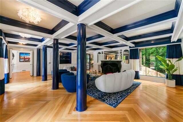 living room with beamed ceiling, parquet floors, a chandelier, coffered ceiling, and crown molding