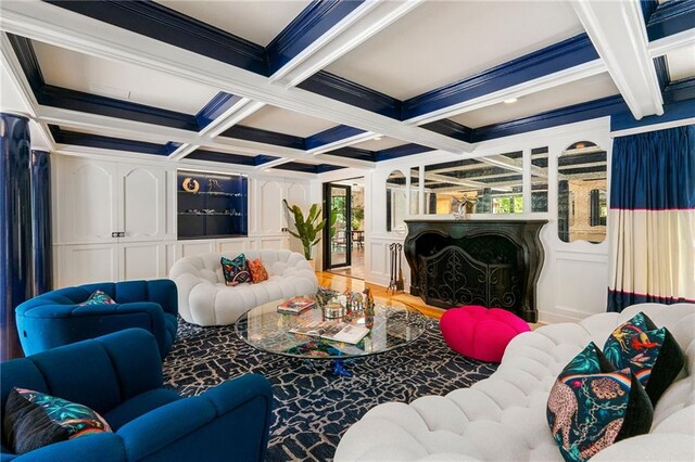 living room with coffered ceiling, beamed ceiling, and crown molding