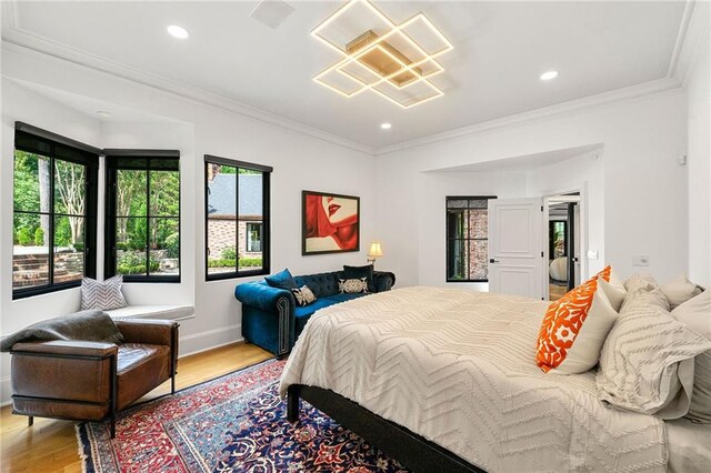 bedroom with ornamental molding and light wood-type flooring