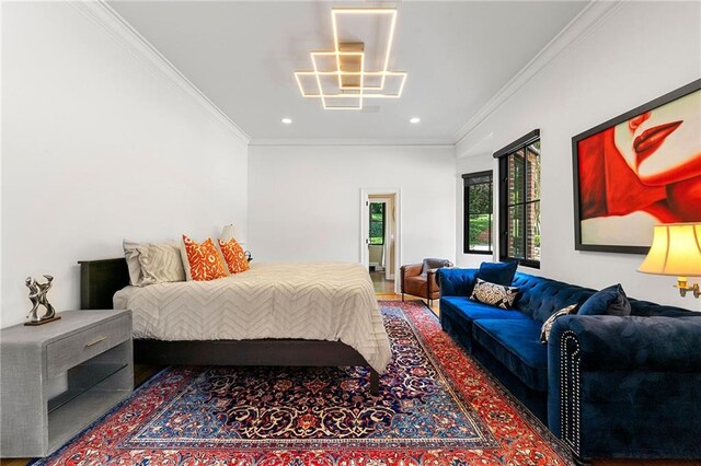 bedroom with ornamental molding and hardwood / wood-style floors