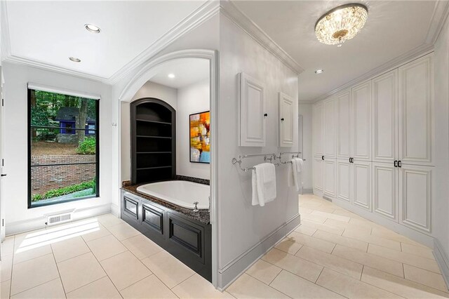 bathroom featuring a bathtub, crown molding, and tile patterned floors