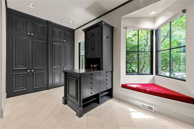 spacious closet with light tile patterned floors