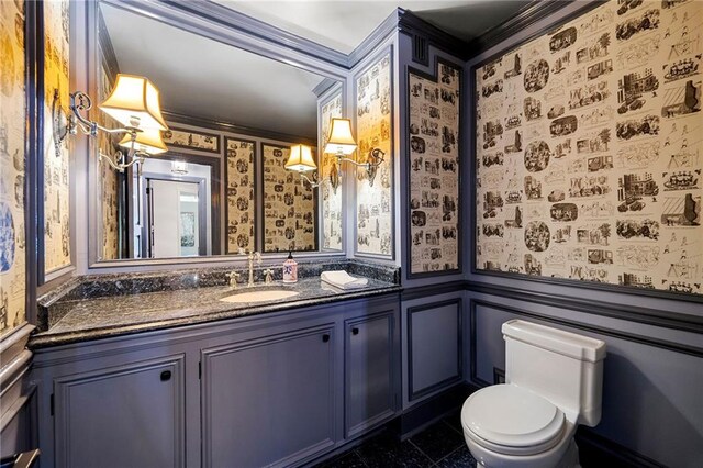 bathroom featuring vanity, crown molding, toilet, and tile patterned flooring