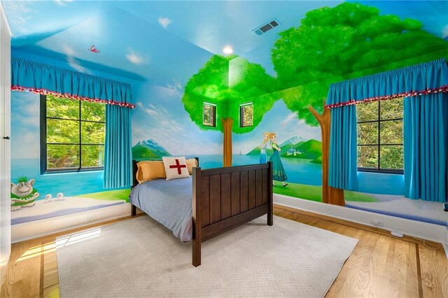 bedroom featuring vaulted ceiling and hardwood / wood-style flooring