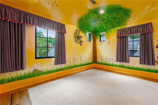 spare room featuring hardwood / wood-style flooring and a healthy amount of sunlight